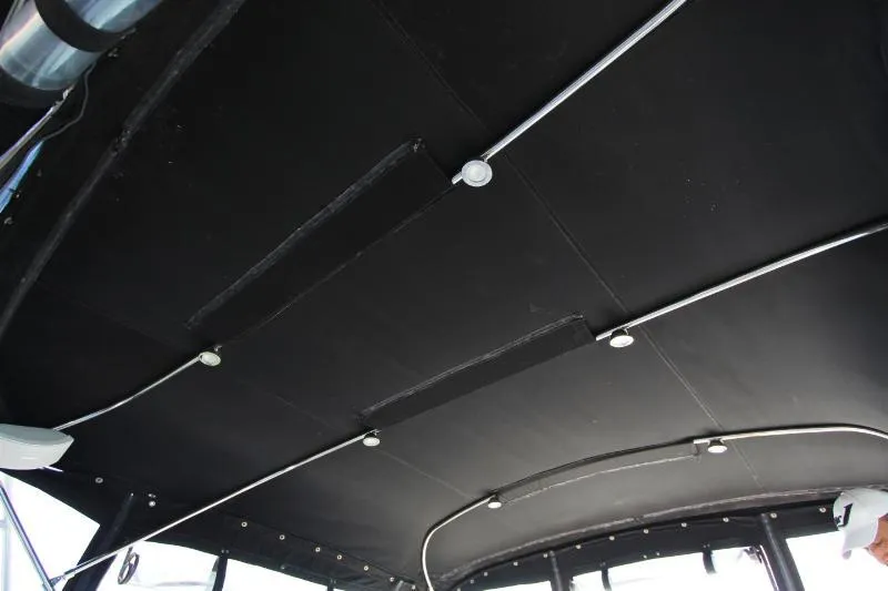  Yacht Photos Pics Ceiling view of a 1999 Azimut 58 yacht with black paneling and lighting fixtures.