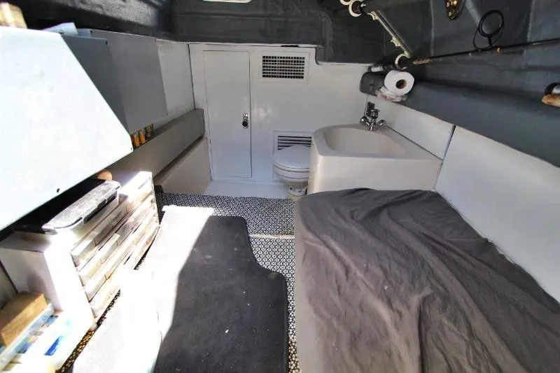  Yacht Photos Pics 1999 Azimut 58 yacht interior with bed, sink, and storage.