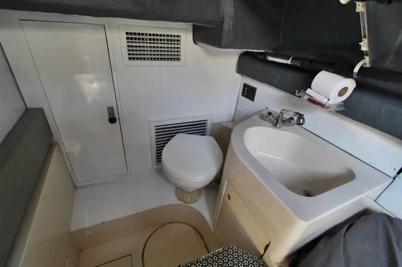  Yacht Photos Pics Bathroom interior of a 1999 Azimut 58 yacht, featuring a toilet and sink.