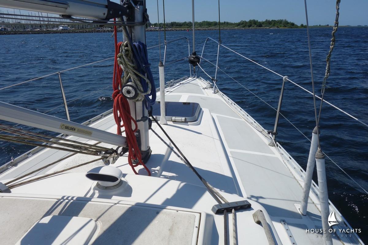 Sailboat deck view, Victoire 855, 1990 model, sailing on calm blue waters.