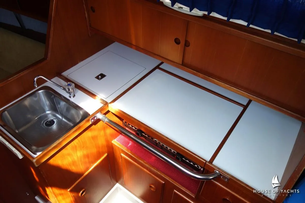 Victoire 855 yacht kitchen with sink and wooden cabinetry, 1990 model.