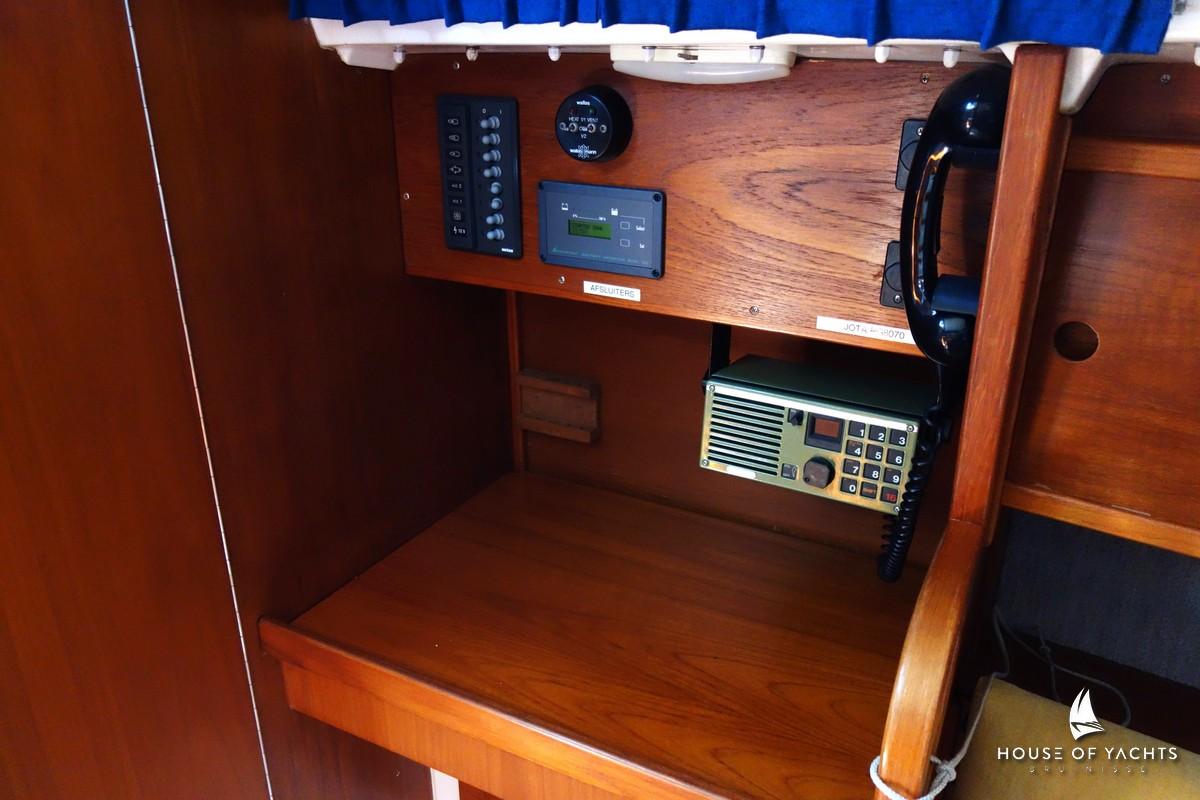 Wooden yacht interior with communication equipment, featuring a Victoire 855 model from 1990.