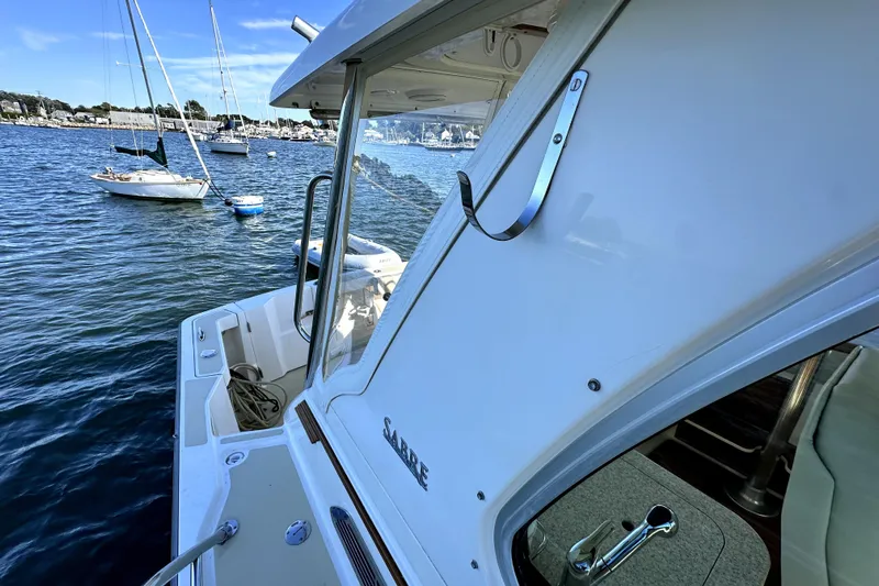 Destiny Yacht Photos Pics 2007 Sabre 34 Express yacht docked in a marina, with sailboats in the background.