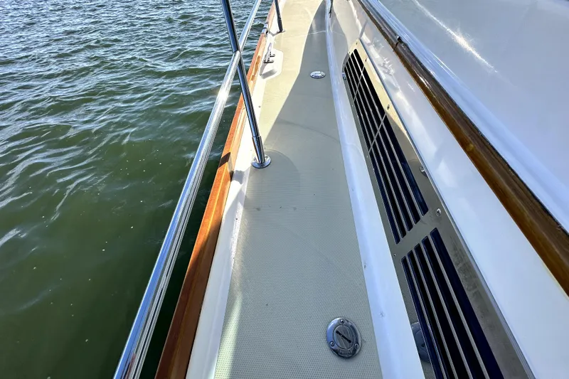 Destiny Yacht Photos Pics 2007 Sabre 34 Express boat deck with railing, cruising on water.