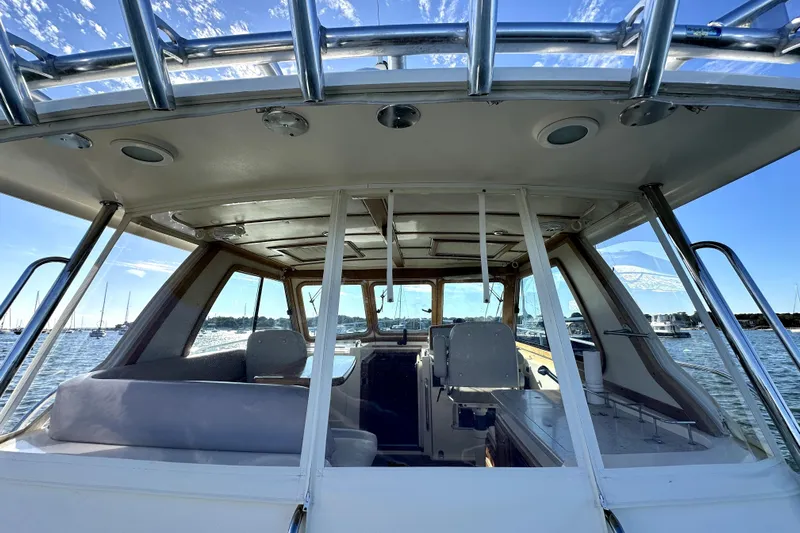 Destiny Yacht Photos Pics 2007 Sabre 34 Express boat interior with seating, windows, and water view.