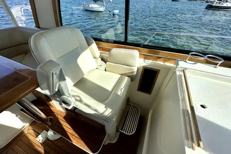 Destiny Yacht Photos Pics Captain's chair on 2007 Sabre 34 Express yacht, overlooking serene waters.