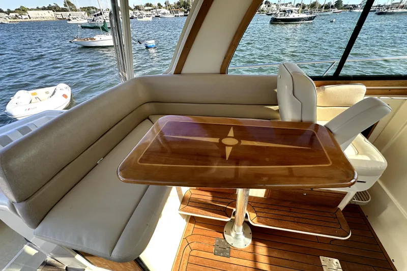 Destiny Yacht Photos Pics 2007 Sabre 34 Express yacht interior with wooden table and cushioned seating.