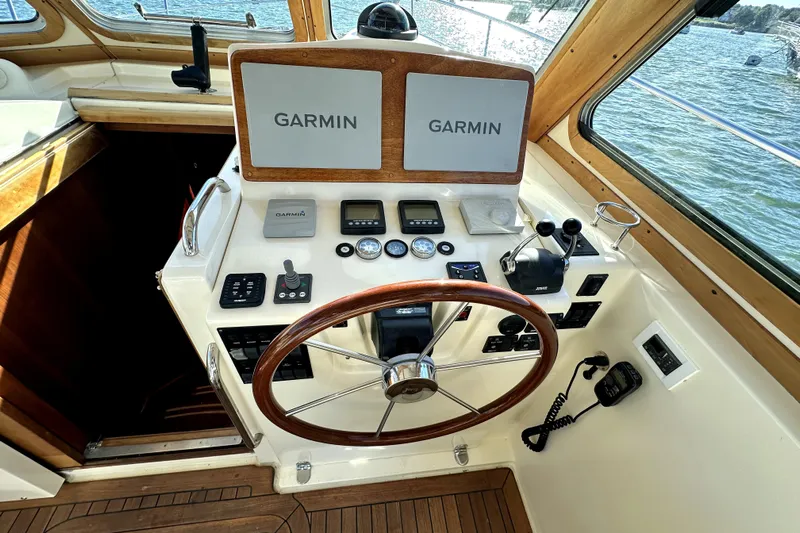 Destiny Yacht Photos Pics 2007 Sabre 34 Express helm with Garmin navigation, wooden steering wheel, and control panel.