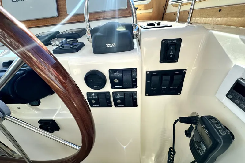 Destiny Yacht Photos Pics 2007 Sabre 34 Express helm with controls, switches, and wooden steering wheel.