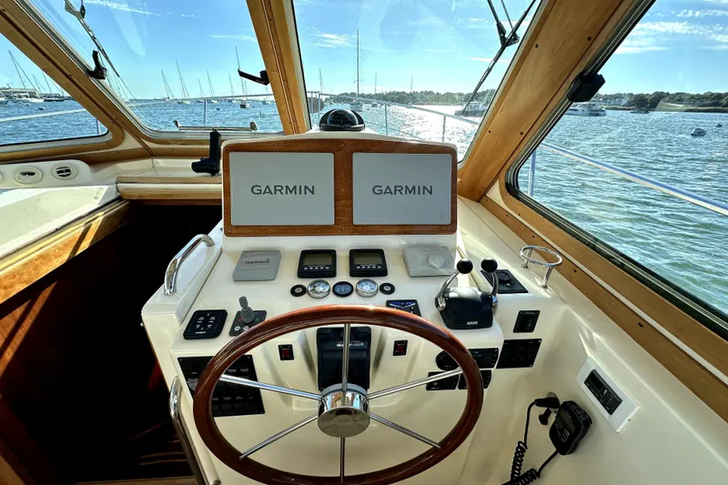 Destiny Yacht Photos Pics 2007 Sabre 34 Express helm with Garmin navigation, overlooking a scenic marina.