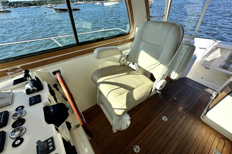 Destiny Yacht Photos Pics 2007 Sabre 34 Express helm with leather captain's chair and wooden steering wheel.