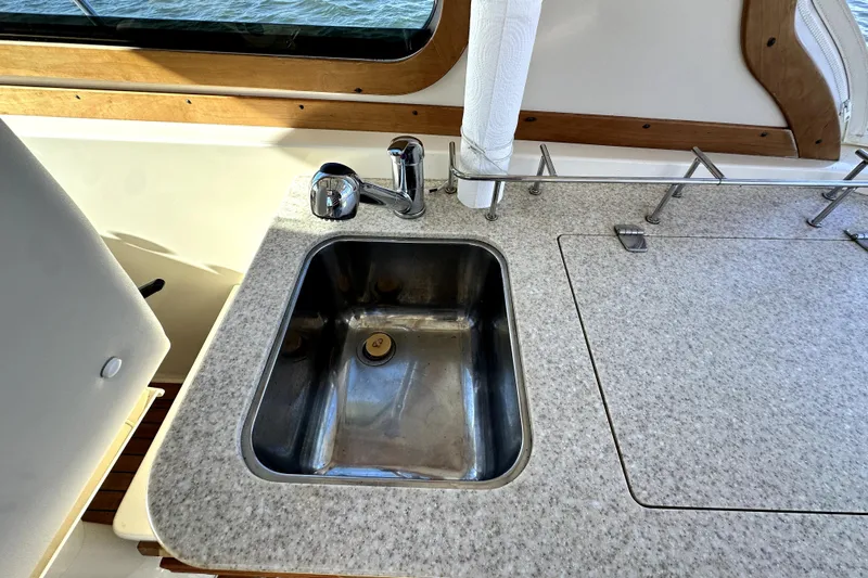 Destiny Yacht Photos Pics 2007 Sabre 34 Express yacht kitchen sink with granite countertop and faucet.