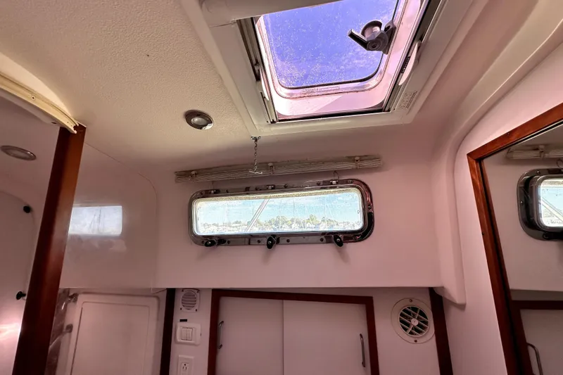 Destiny Yacht Photos Pics Interior cabin view of a 2007 Sabre 34 Express boat with skylight and porthole.