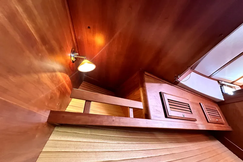 Destiny Yacht Photos Pics Interior of 2007 Sabre 34 Express boat with wooden paneling and wall light.