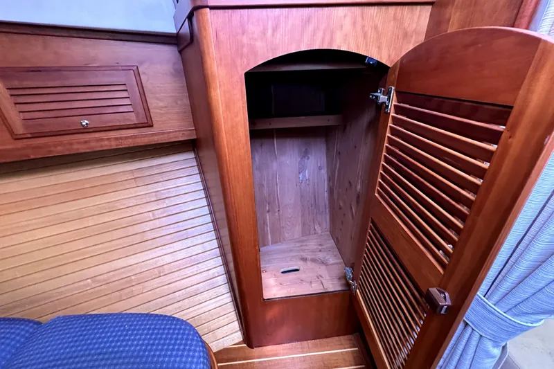 Destiny Yacht Photos Pics 2007 Sabre 34 Express interior wooden cabinet with open door, showcasing storage space.