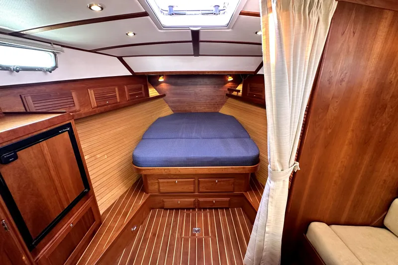 Destiny Yacht Photos Pics Luxurious 2007 Sabre 34 Express cabin interior with wood finish and cozy bed.