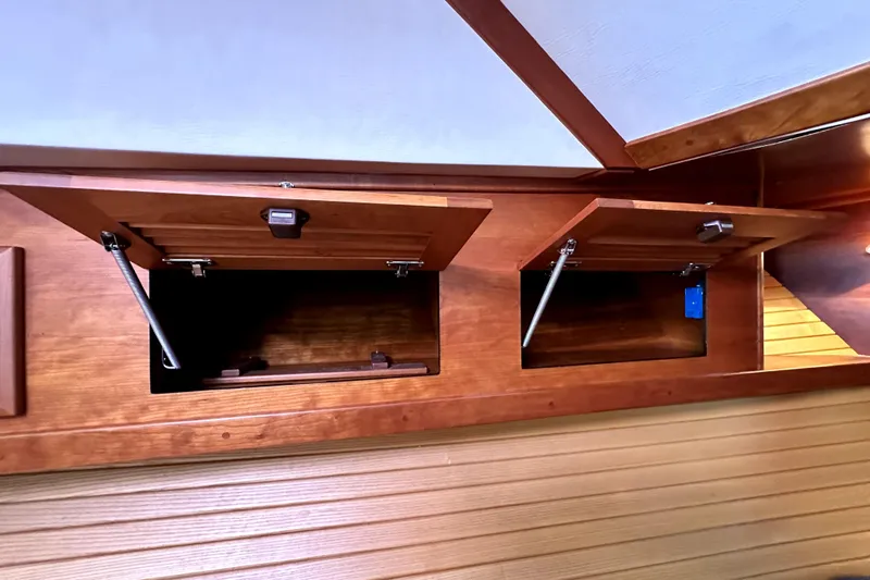 Destiny Yacht Photos Pics Wooden cabinets inside a 2007 Sabre 34 Express boat, showcasing open storage compartments.