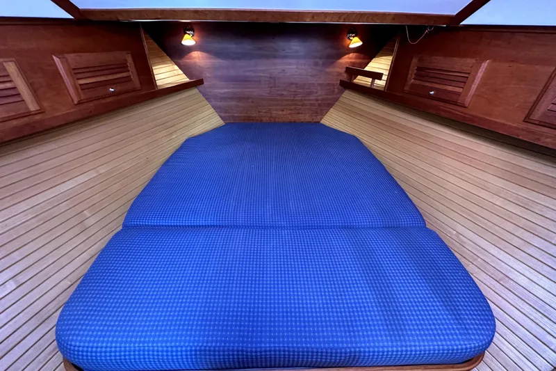 Destiny Yacht Photos Pics 2007 Sabre 34 Express cabin with blue bedding and wooden interior.