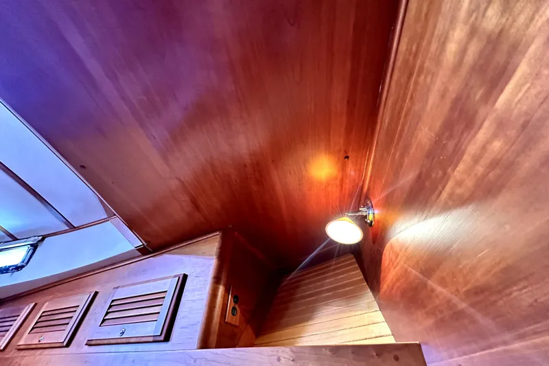 Destiny Yacht Photos Pics Interior of 2007 Sabre 34 Express boat with wooden paneling and ceiling light.