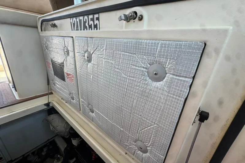 Destiny Yacht Photos Pics 2007 Sabre 34 Express engine compartment with insulated cover and visible registration number.