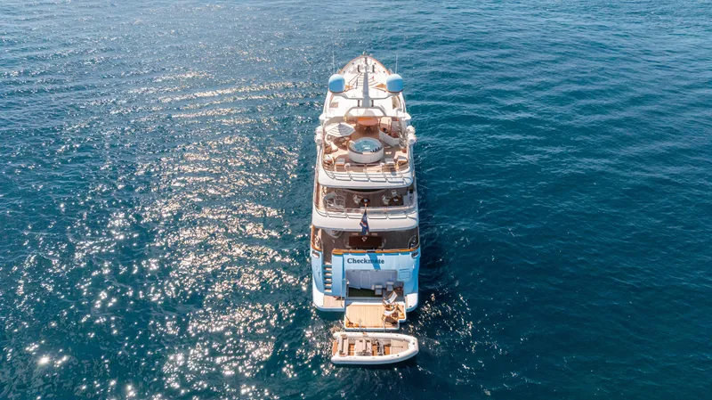 Checkmate Yacht Photos Pics Aerial view of 2013 Benetti 44 yacht on open sea with tender boat.