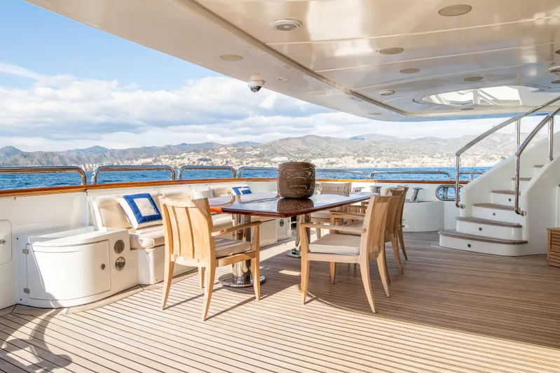 Checkmate Yacht Photos Pics Luxurious Benetti 44 yacht deck with elegant dining area, ocean view, and modern design, 2013 model.