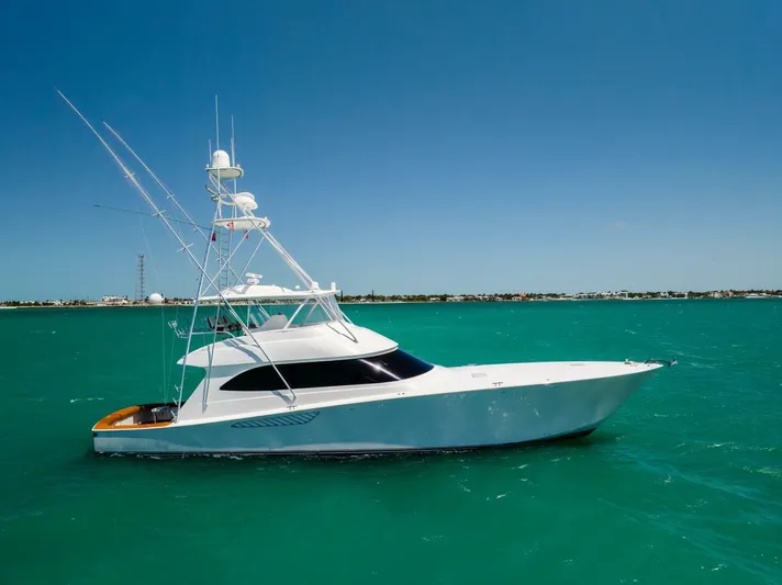 Mighty Mouse Yacht Photos Pics 2011 Viking 70 Convertible yacht on turquoise water under clear blue sky.