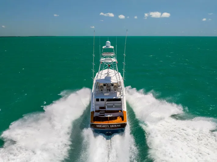 Mighty Mouse Yacht Photos Pics Viking 70 Convertible yacht cruising on turquoise waters, rear view, 2011 model.