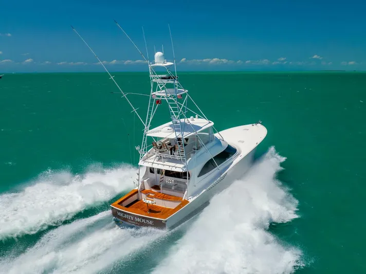 Mighty Mouse Yacht Photos Pics 2011 Viking 70 Convertible yacht cruising on turquoise waters under clear skies.