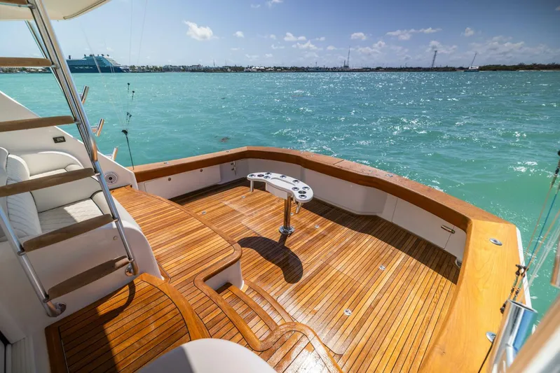 Mighty Mouse Yacht Photos Pics Luxurious 2011 Viking 70 Convertible yacht deck with wooden flooring, overlooking serene blue waters.
