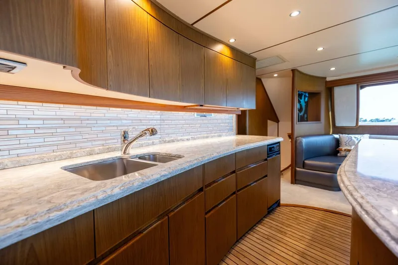 Mighty Mouse Yacht Photos Pics Luxurious kitchen interior of 2011 Viking 70 Convertible yacht with modern design and wooden cabinetry.