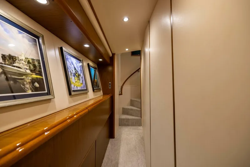 Mighty Mouse Yacht Photos Pics Luxurious interior hallway of a 2011 Viking 70 Convertible yacht with framed artwork.