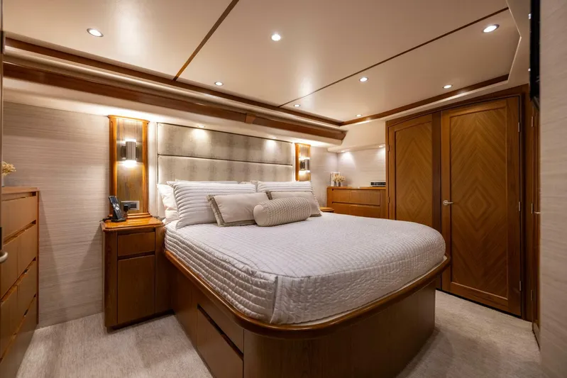 Mighty Mouse Yacht Photos Pics Luxurious bedroom interior of 2011 Viking 70 Convertible yacht with elegant wood finishes.