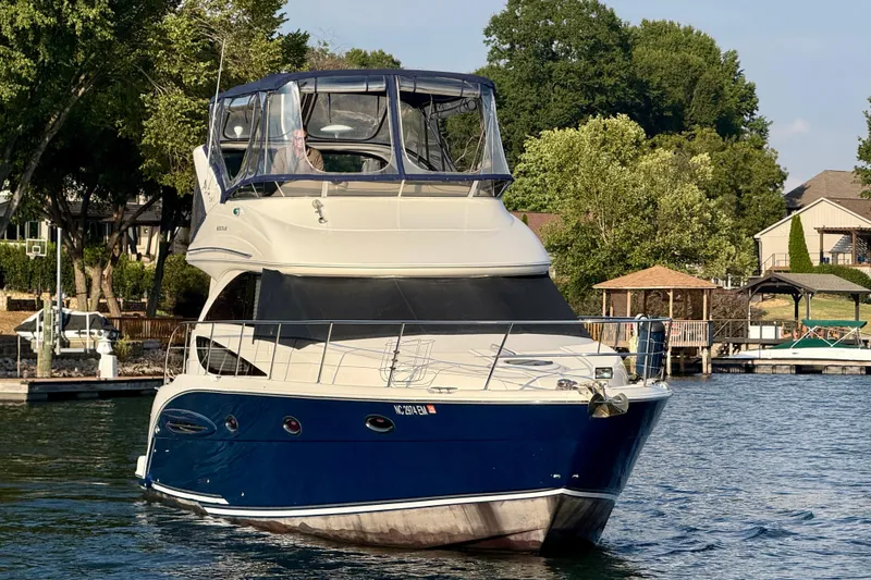 Freshwater Boat- New Trade-in- Obo Yacht Photos Pics 2011 Meridian 341 Sedan yacht on a serene lake with lush greenery.