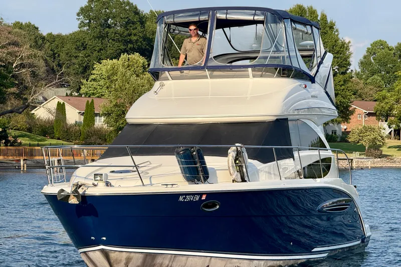 Freshwater Boat- New Trade-in- Obo Yacht Photos Pics 2011 Meridian 341 Sedan yacht on a serene lake with lush greenery.