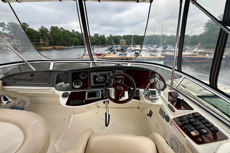 Freshwater Boat- New Trade-in- Obo Yacht Photos Pics Interior view of 2011 Meridian 341 Sedan yacht cockpit with marina backdrop.