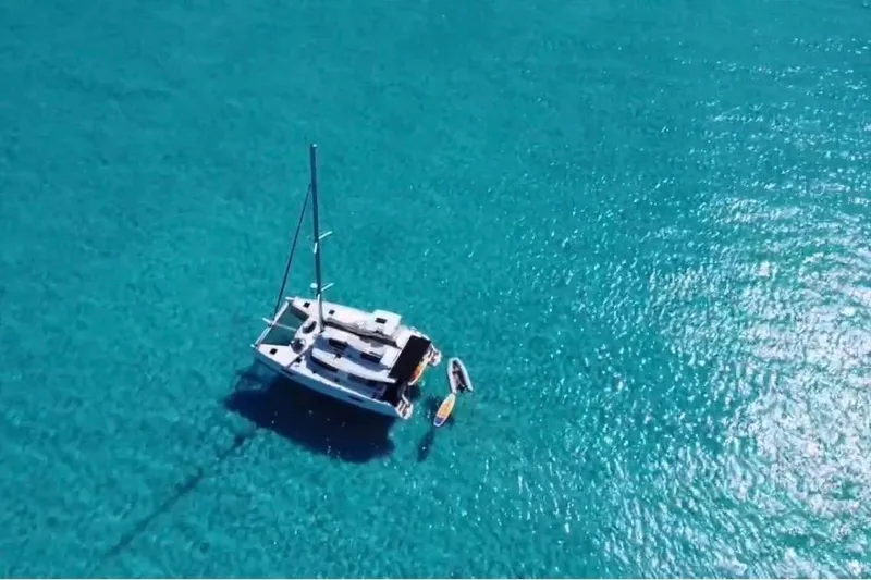Monseas Yacht Photos Pics Aerial view of 2014 Fountaine Pajot Helia 44 catamaran on clear turquoise water.