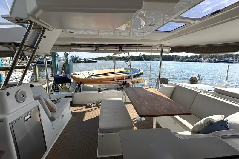 Monseas Yacht Photos Pics Spacious deck of 2014 Fountaine Pajot Helia 44 catamaran with seating and scenic marina view.