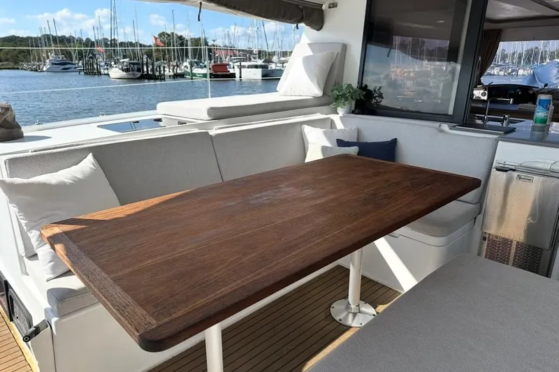 Monseas Yacht Photos Pics Luxurious 2014 Fountaine Pajot Helia 44 yacht with elegant outdoor seating and wooden table.