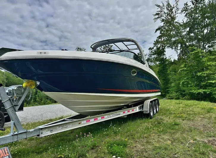  Yacht Photos Pics 2015 Sea Ray 300 SLX boat on trailer, parked on grass, under cloudy sky.