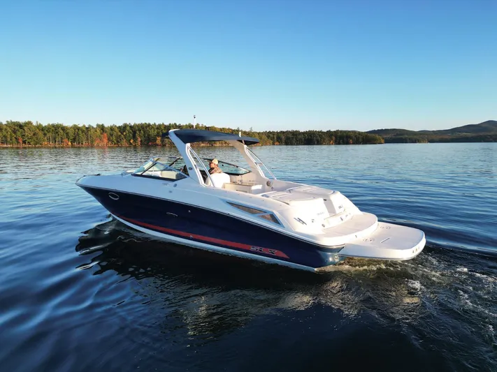  Yacht Photos Pics 2015 Sea Ray 300 SLX cruising on a serene lake under a clear blue sky.