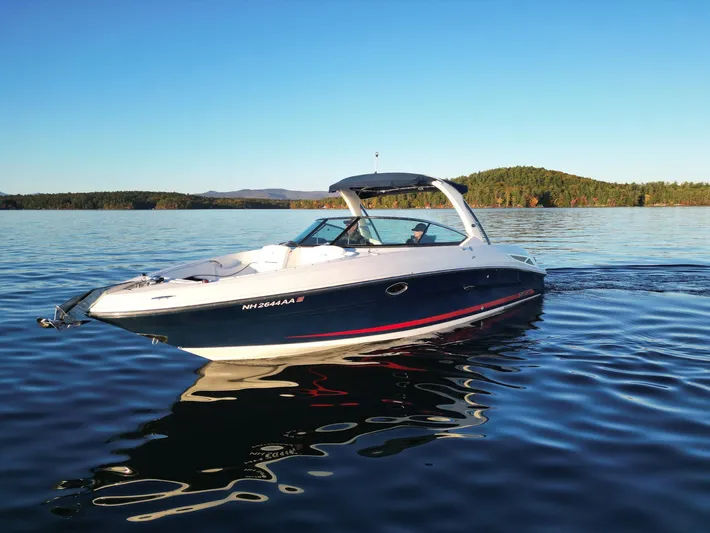  Yacht Photos Pics 2015 Sea Ray 300 SLX boat cruising on a serene lake under clear blue skies.