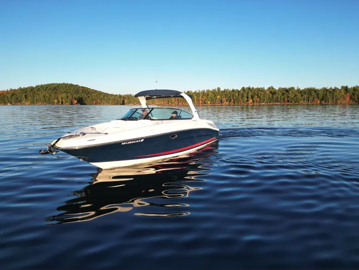  Yacht Photos Pics 2015 Sea Ray 300 SLX boat on a serene lake with forested shoreline.