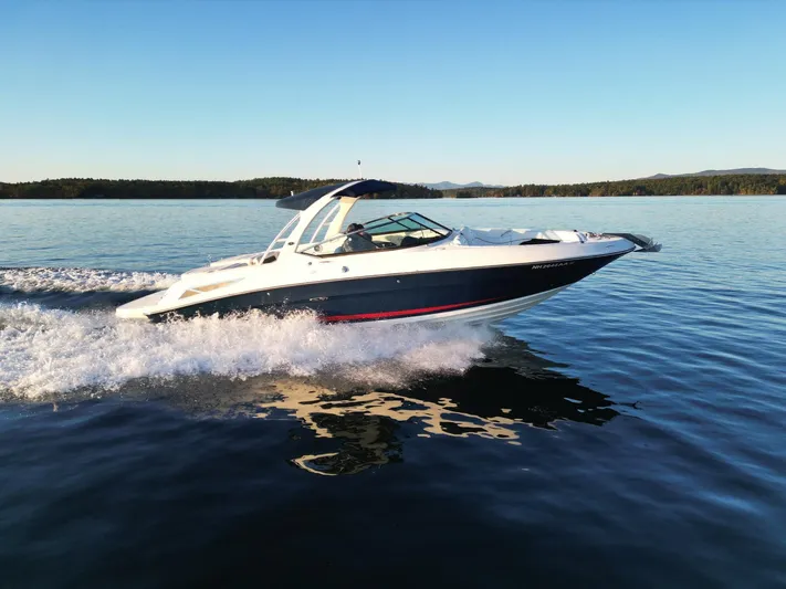  Yacht Photos Pics 2015 Sea Ray 300 SLX speedboat cruising on a calm lake.