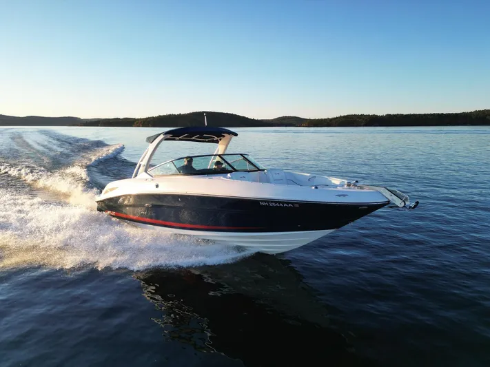  Yacht Photos Pics 2015 Sea Ray 300 SLX speedboat cruising on a serene lake at sunset.