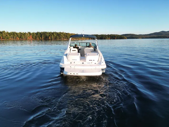  Yacht Photos Pics 2015 Sea Ray 300 SLX boat cruising on a serene lake.