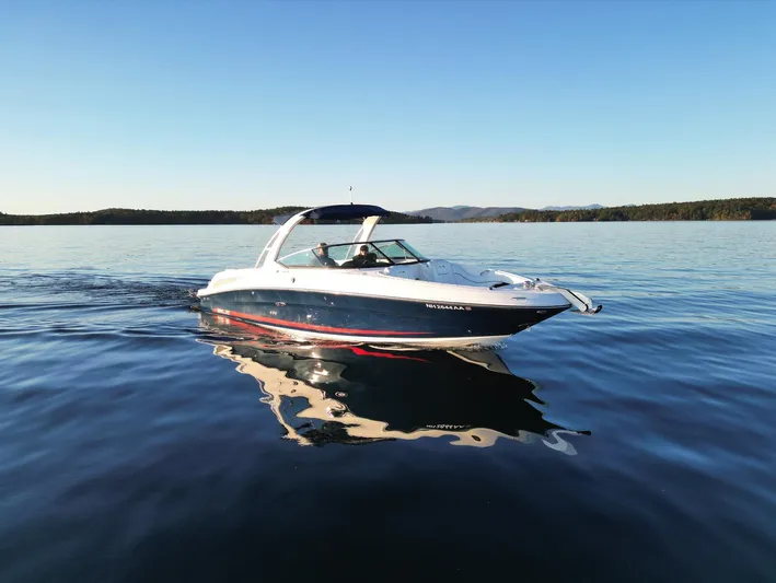  Yacht Photos Pics 2015 Sea Ray 300 SLX cruising on a calm lake under clear blue skies.