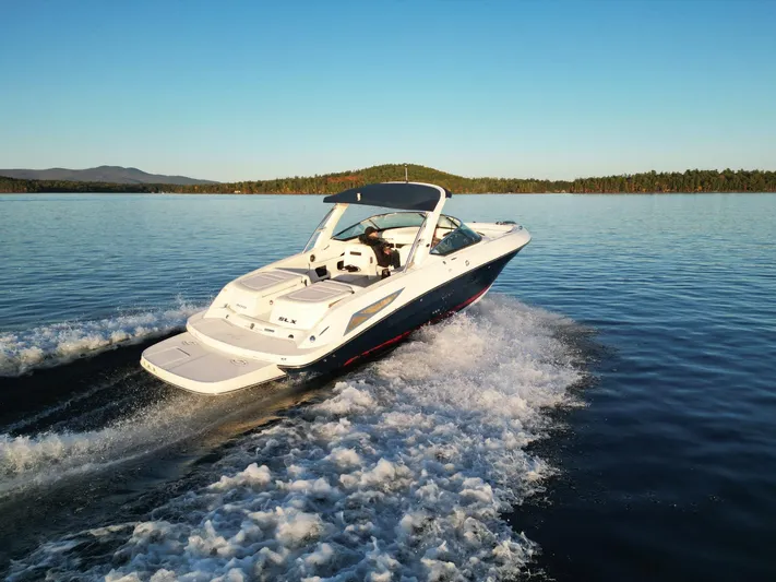  Yacht Photos Pics 2015 Sea Ray 300 SLX cruising on a serene lake at sunset.