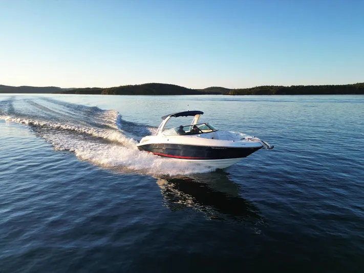  Yacht Photos Pics 2015 Sea Ray 300 SLX cruising on a serene lake at sunset.