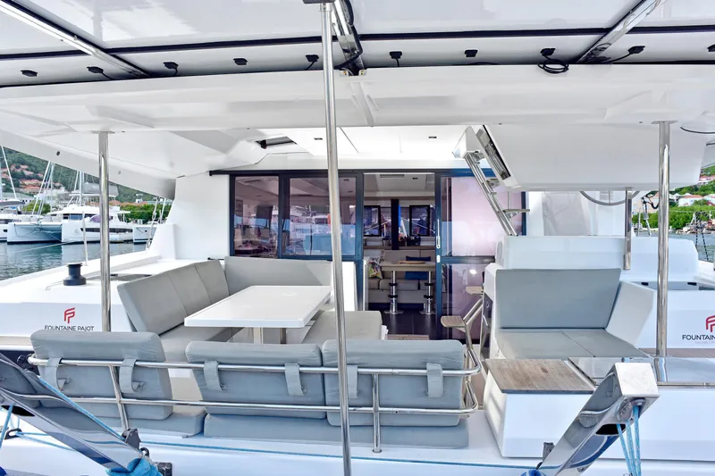 Boomerang Yacht Photos Pics 2022 Fountaine Pajot Astrea 42 yacht interior with modern seating and dining area.